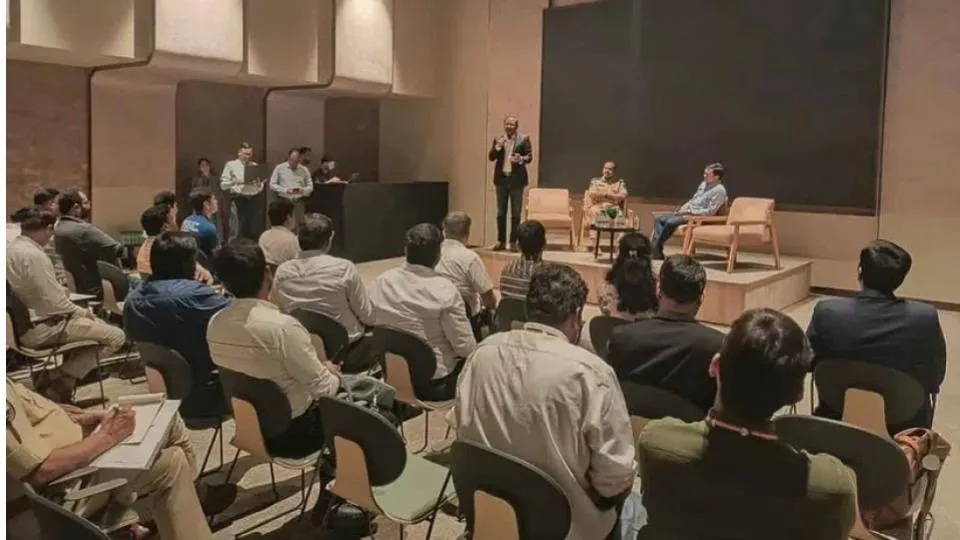 Audience seated in rows facing a panel discussion on a low stage