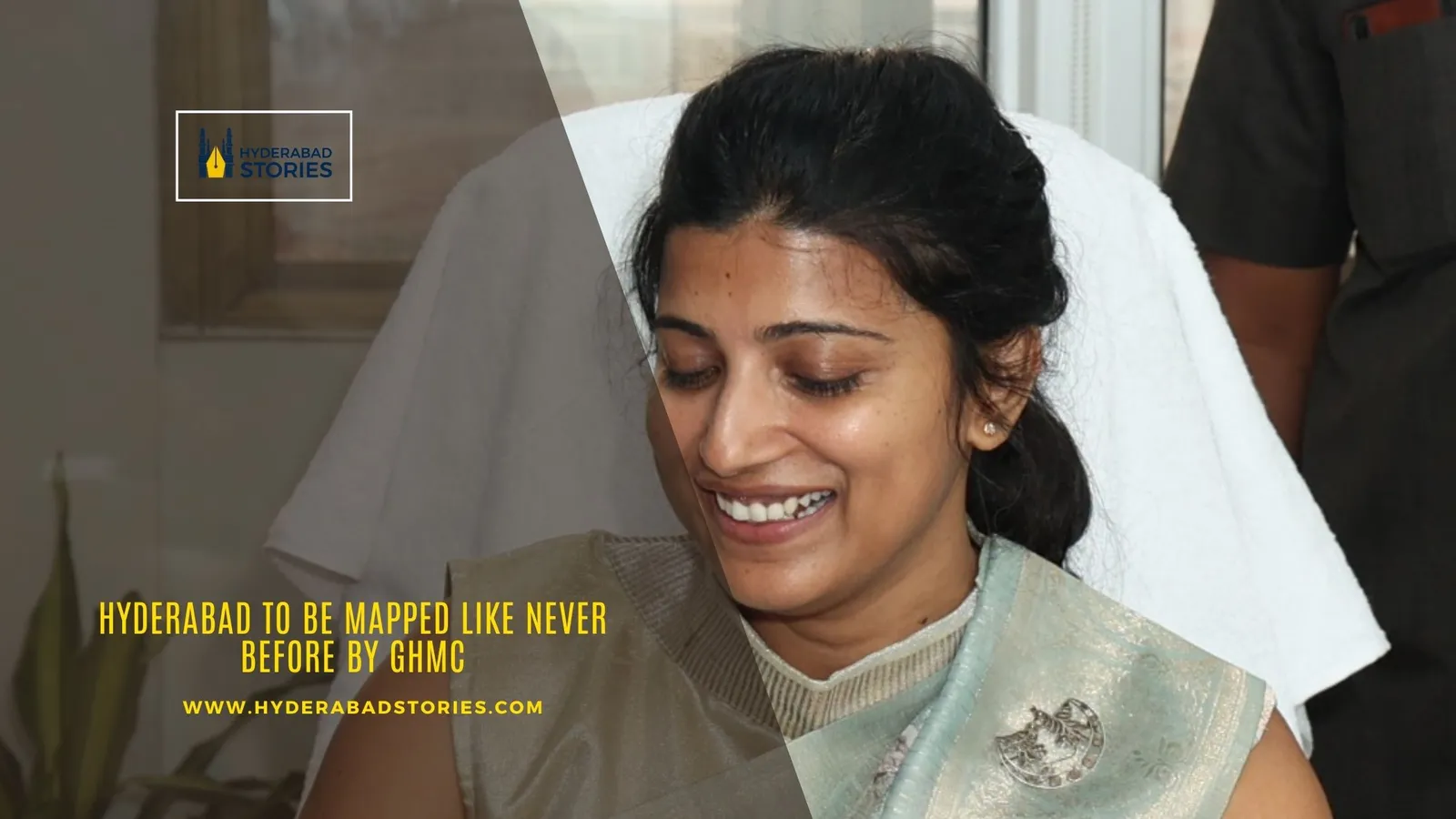 News graphic showing a smiling woman in a sari indoors