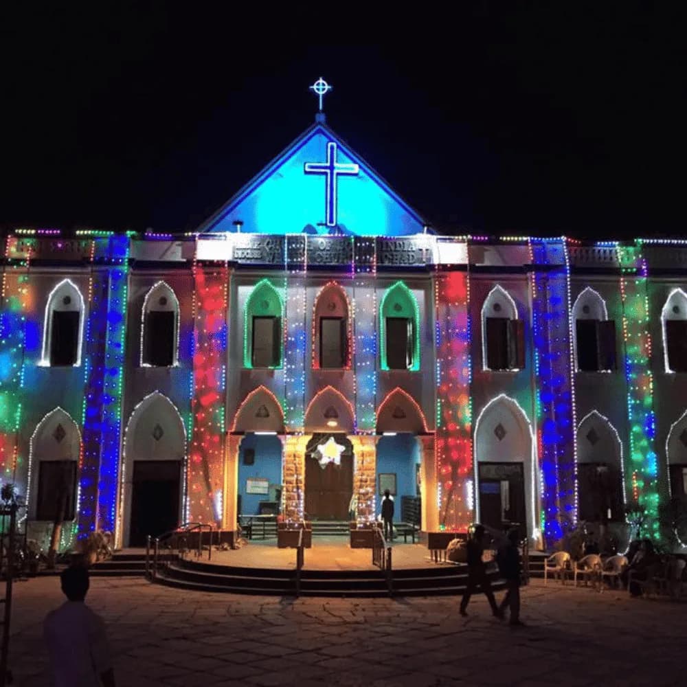 Church facade lit with coloured projections at night