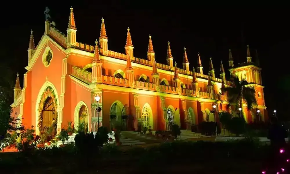 Long arched heritage building floodlit in orange at night