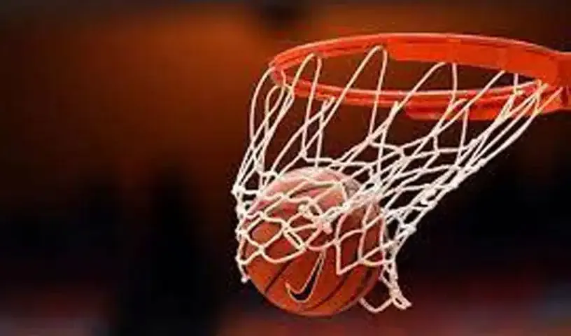 Close-up of a basketball dropping through a hoop and net