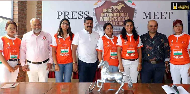 Team in orange kit posed with officials at a press conference