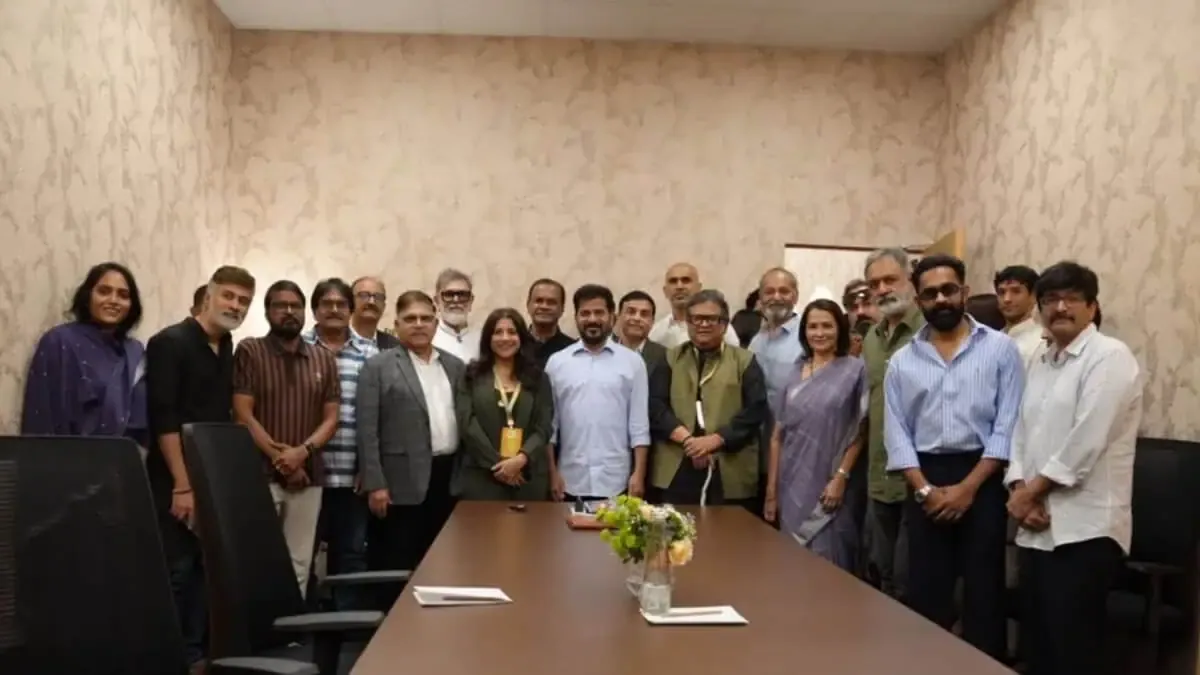 Large group posed around a boardroom table