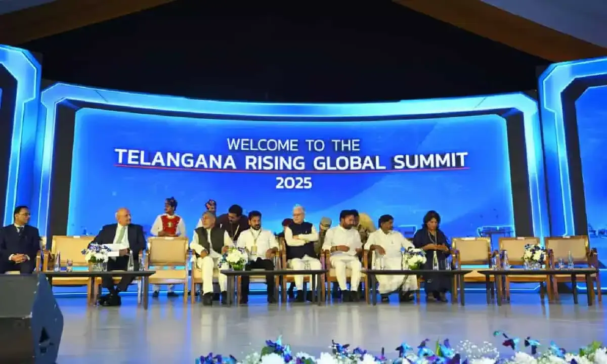Dignitaries seated on a stage before a summit welcome screen