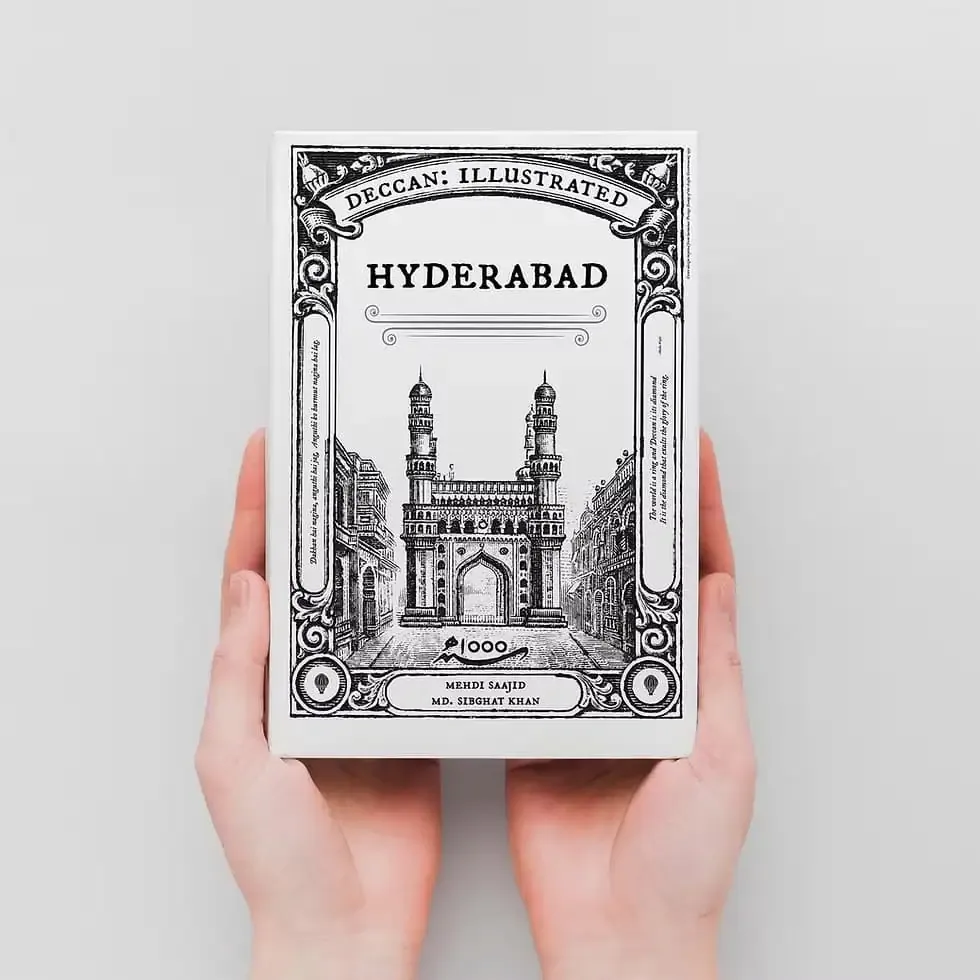 Hands holding a book with a monument illustration on the cover