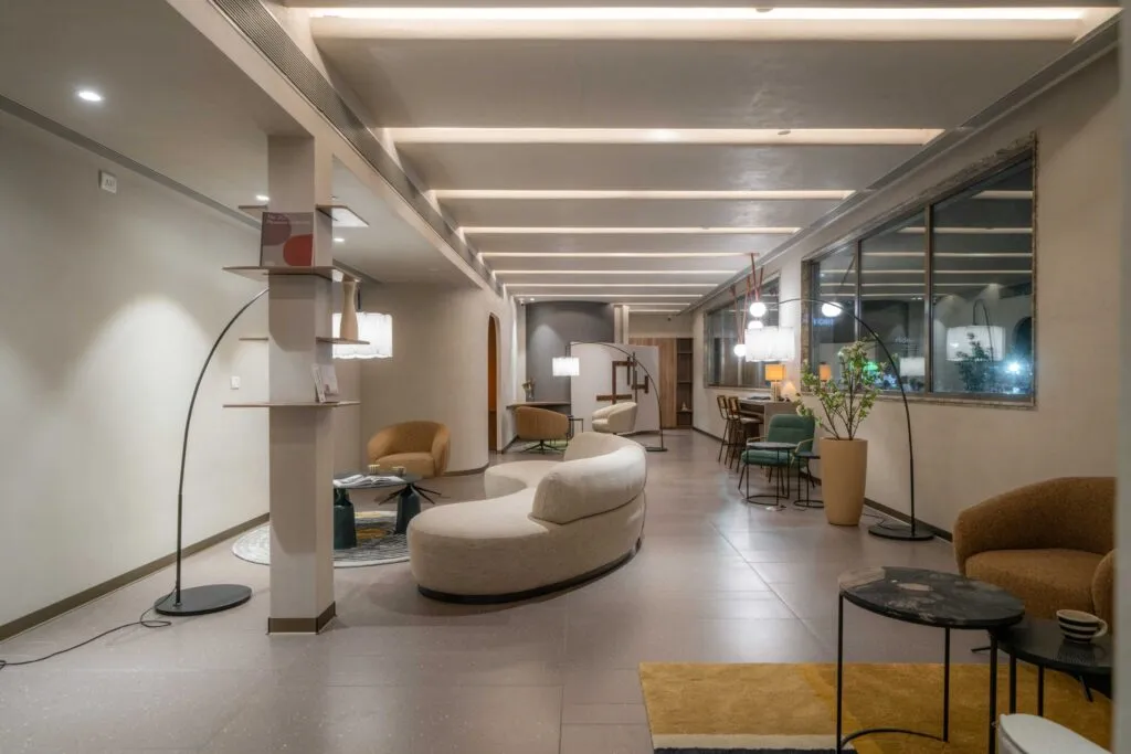 Long lounge corridor with sofas, tables and soft lighting