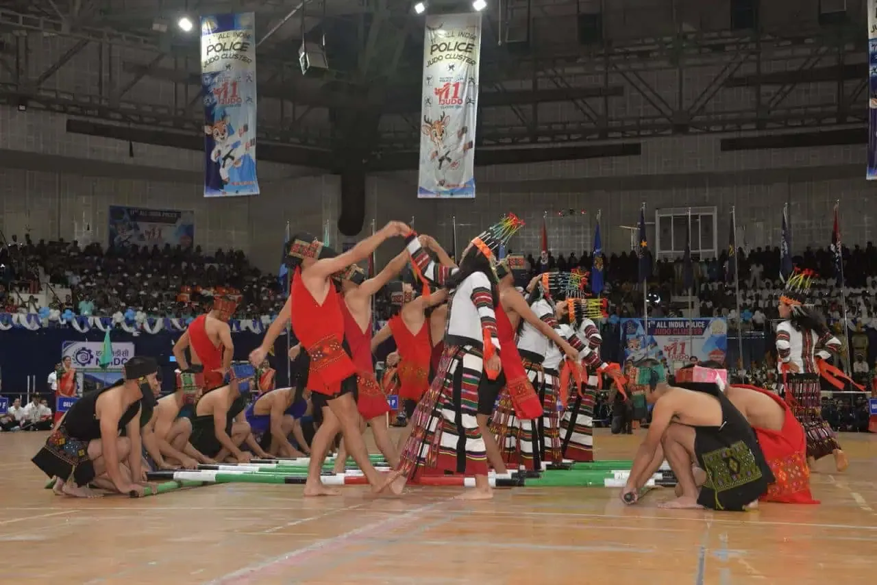 Gymnasts performing a group routine on an arena floor
