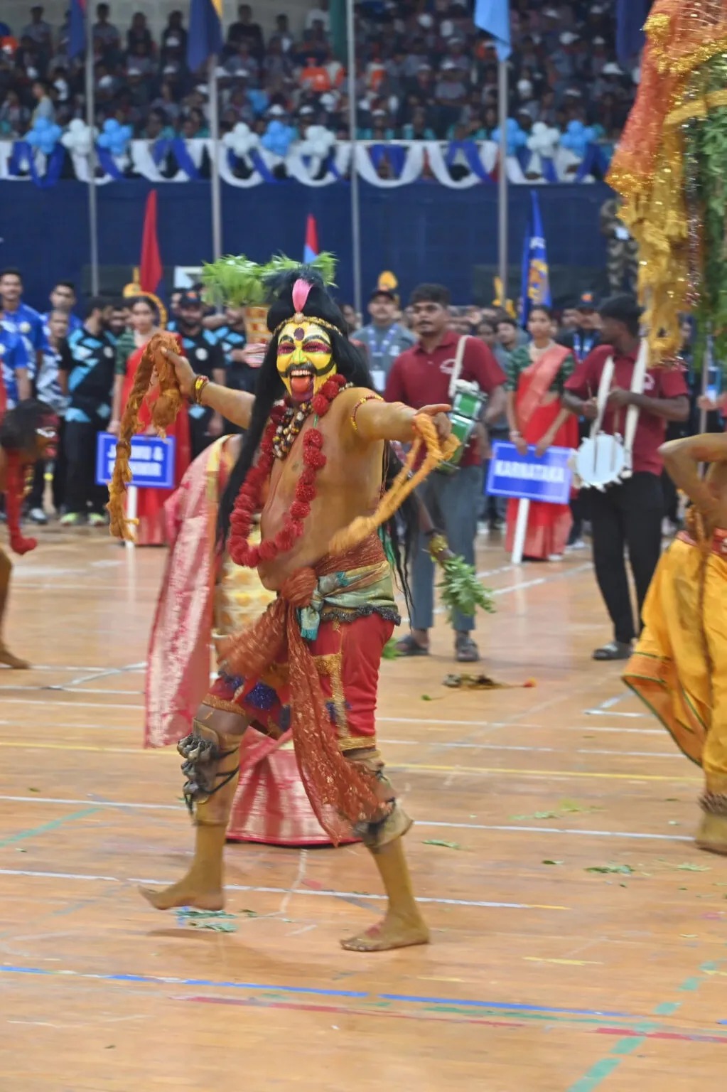 Costumed folk performer dancing before an audience