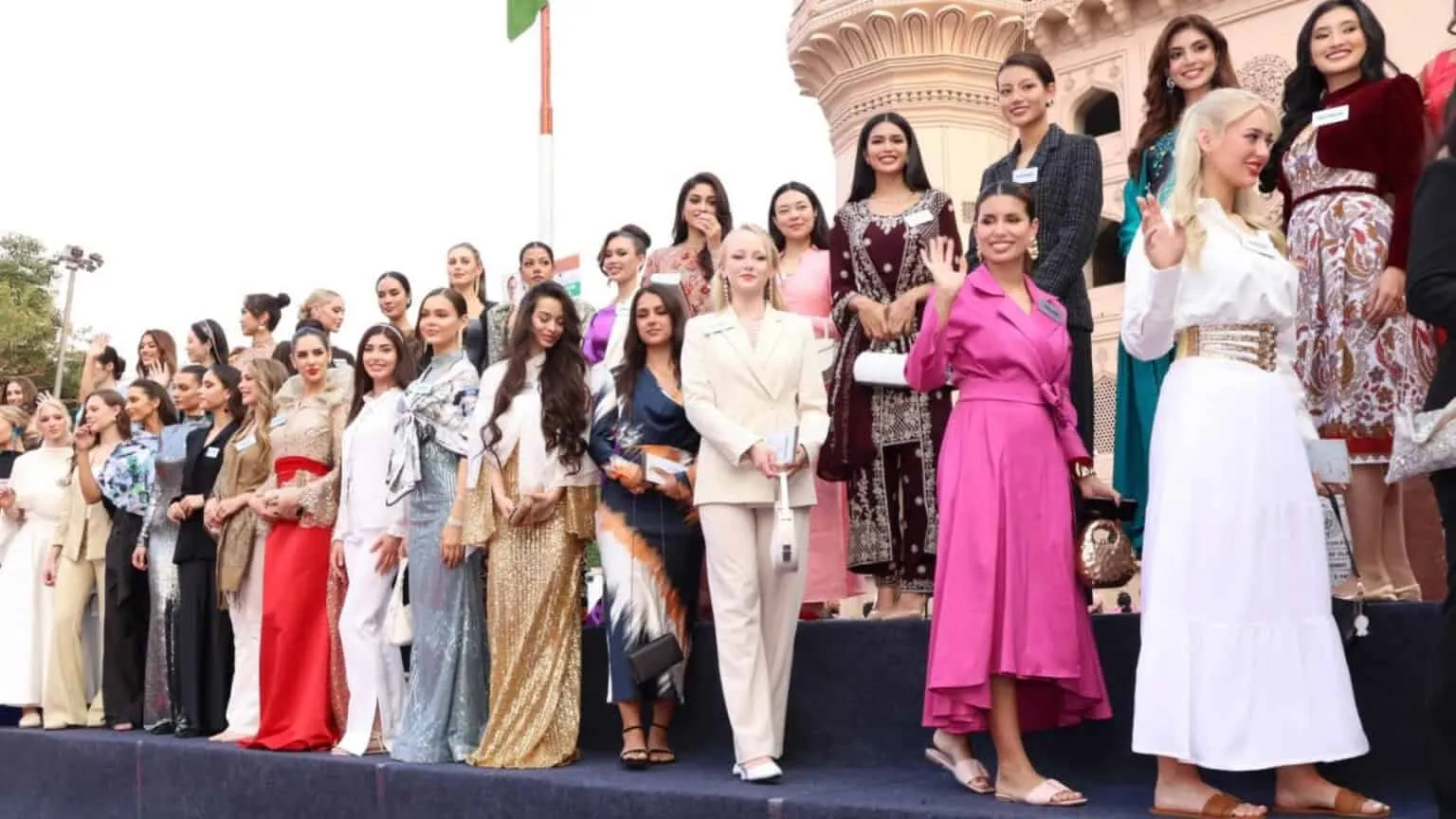 Large group in formal dress posed on an outdoor stage