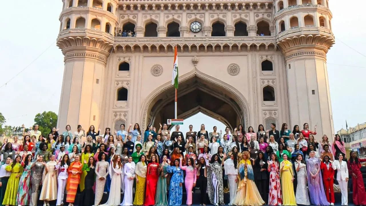 Large group posed before a four-minaret monument