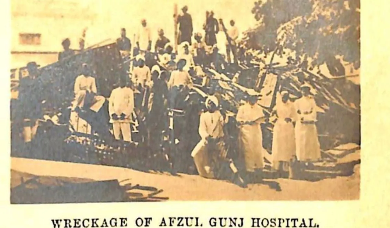 Archival photograph of people beside collapsed buildings