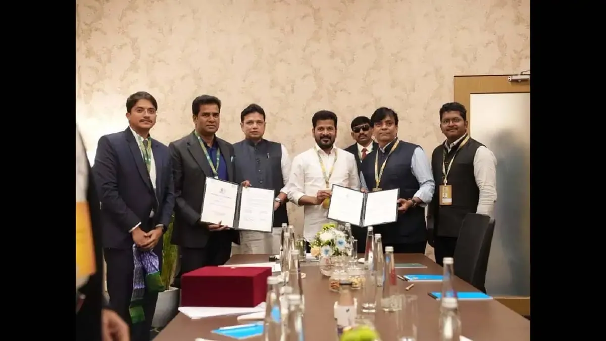 People holding signed documents at a meeting table