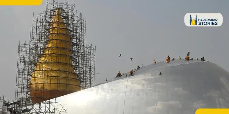 Gilded tower under scaffolding with workers climbing
