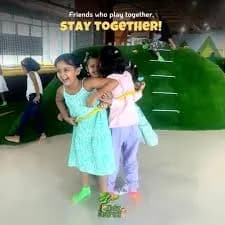 Two children playing together on an indoor play structure