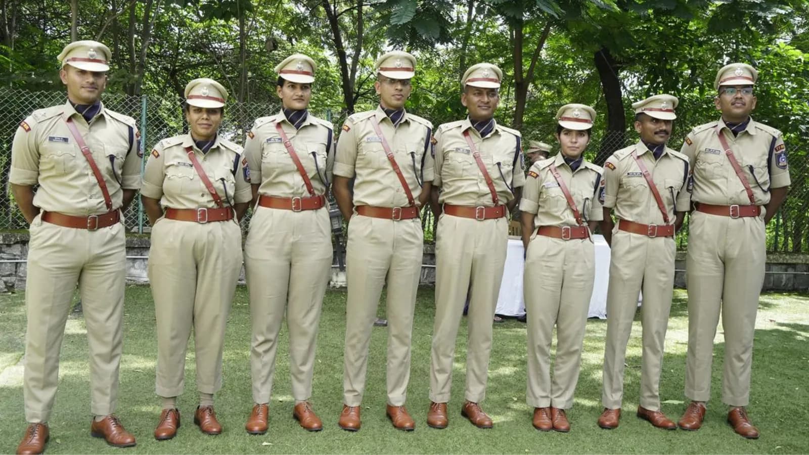 Row of uniformed officers standing on a lawn